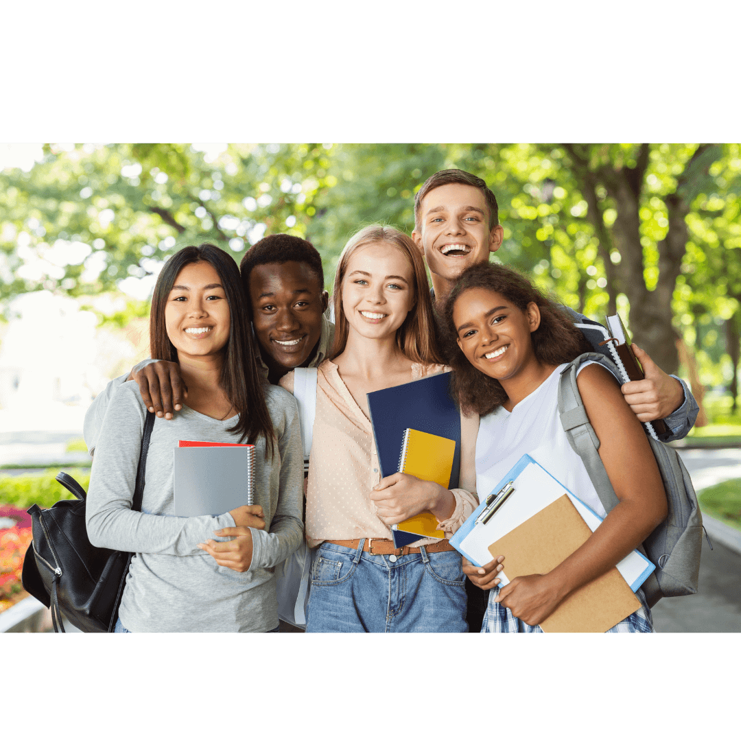 Group of 5 diverse international students pose for a photo holding their backpacks and notebooks.
