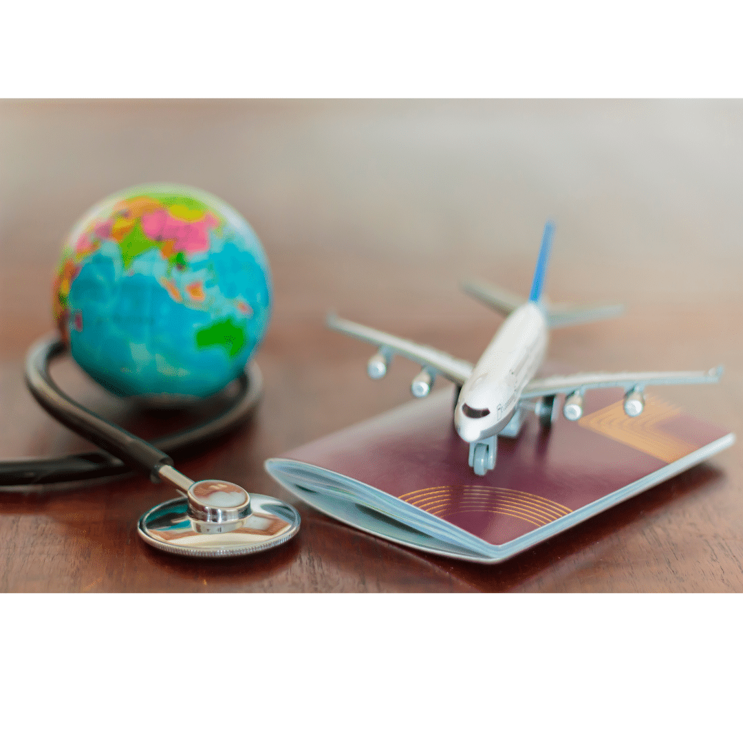 Miniature plane and globe sit near a passport and a stethoscope.