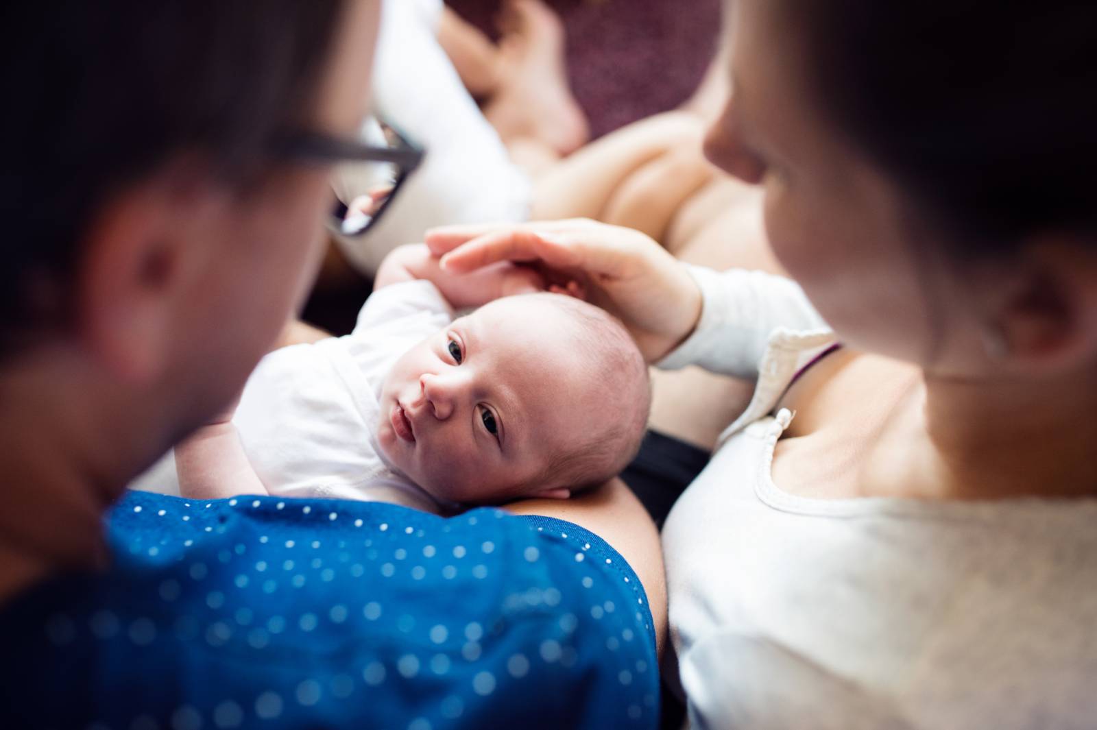 newborn in expat mother's arms, in hospital