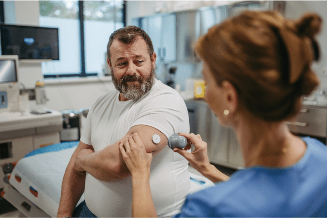 Man having Dexcom for diabetes placed on arm by nurse